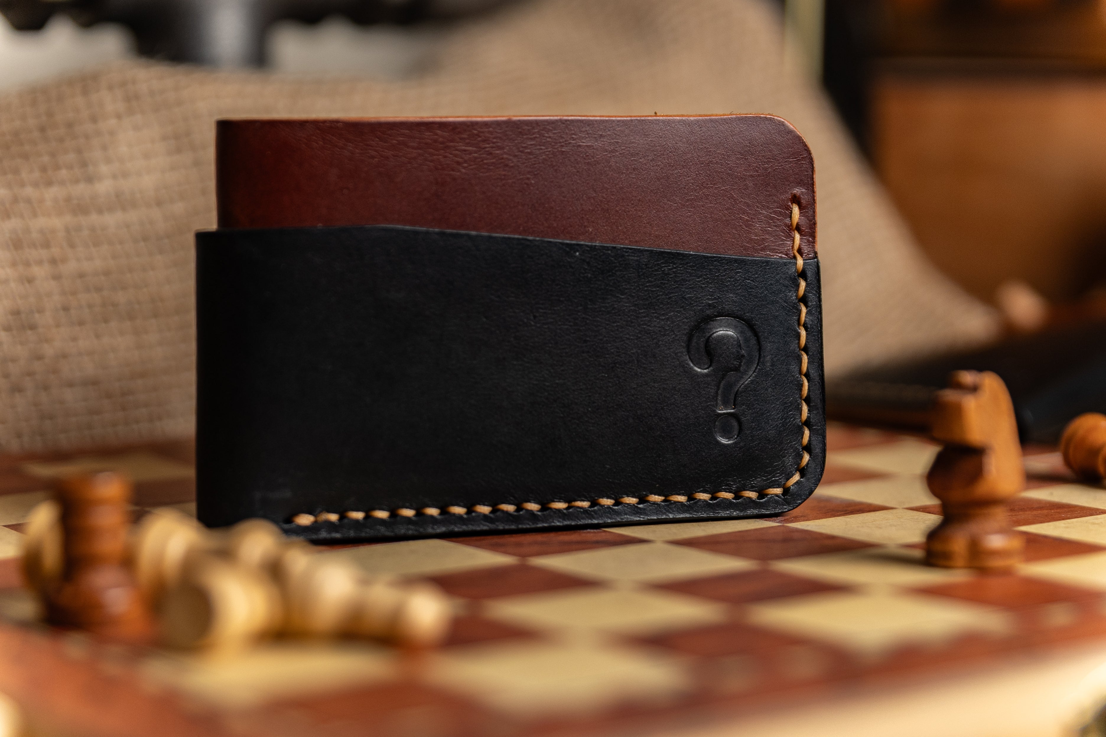Black and brown leather wallet on a chessboard