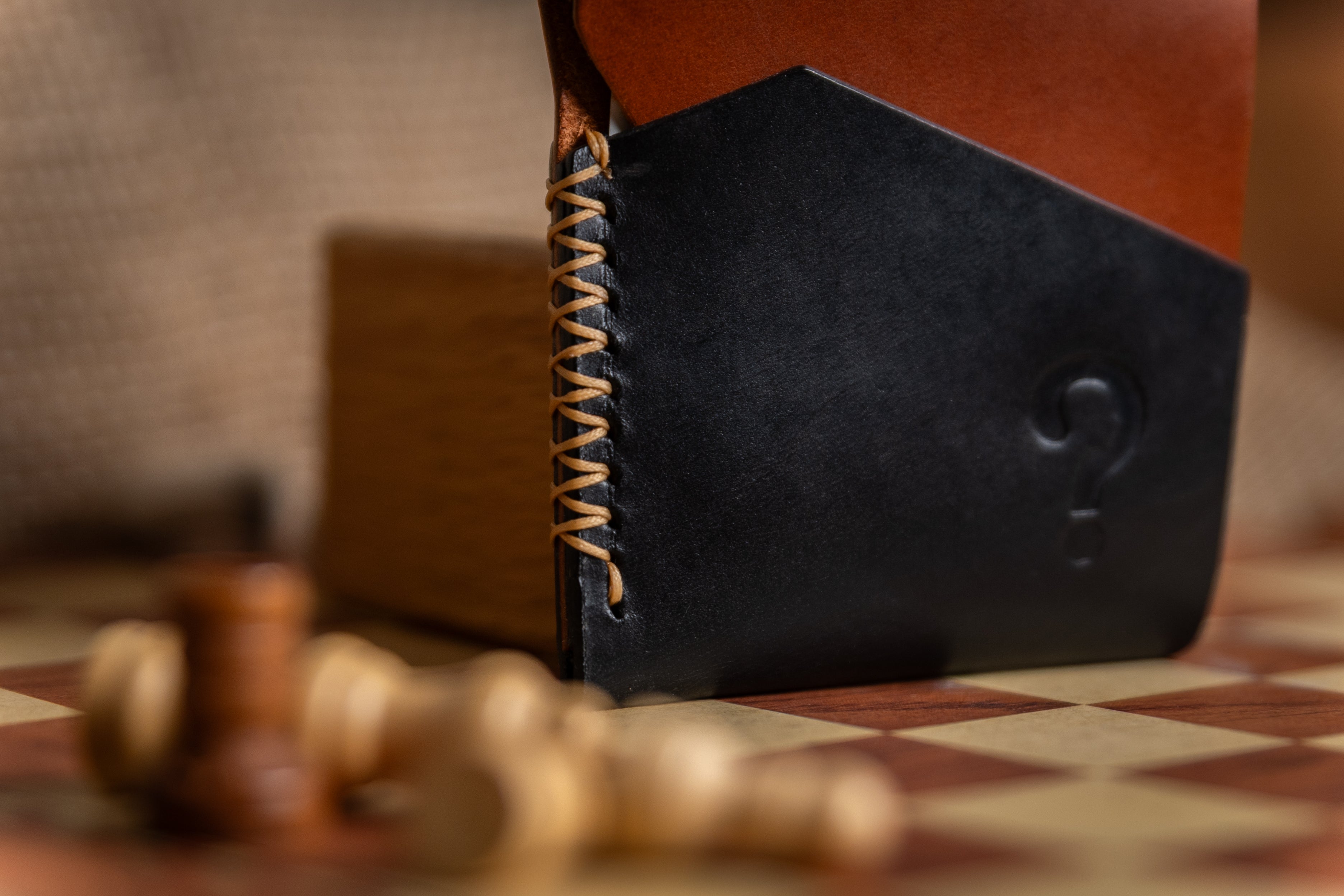 Close-up of a leather-bound book with a checkered surface in the background