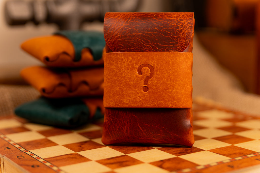 Brown wax leather wallet with a question mark on a checkered table