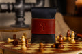 Black walpier buttero leather wallet pouch with a red strap featuring a question mark on a chessboard.