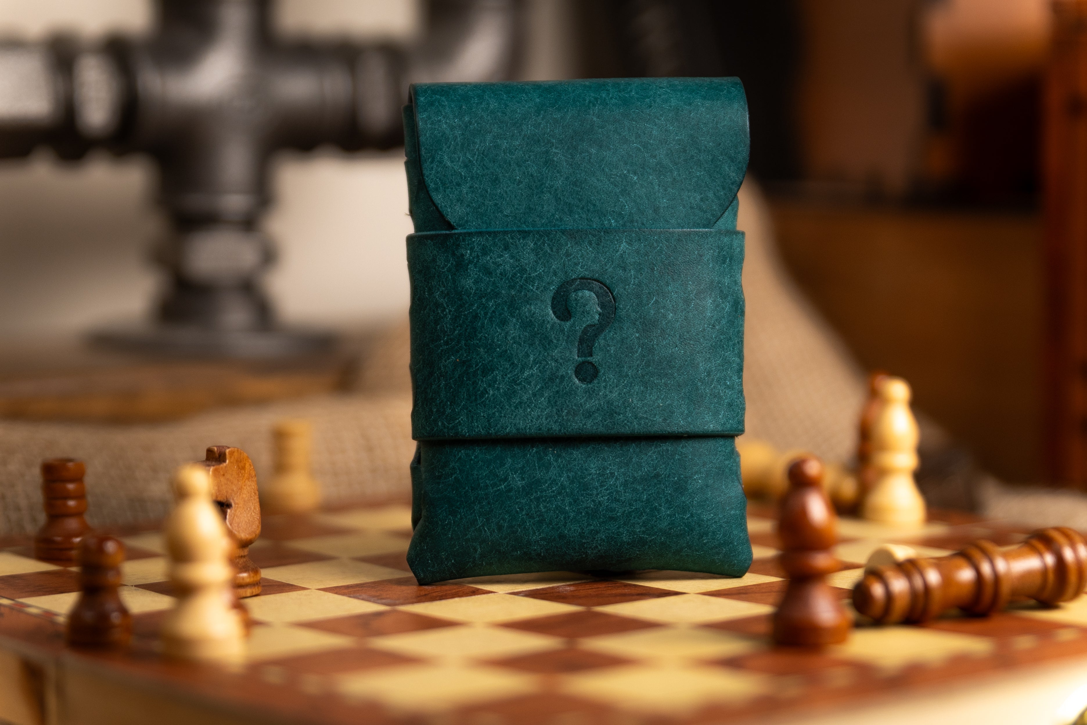 Teal pueblo leather wallet pouch with a question mark on a chessboard