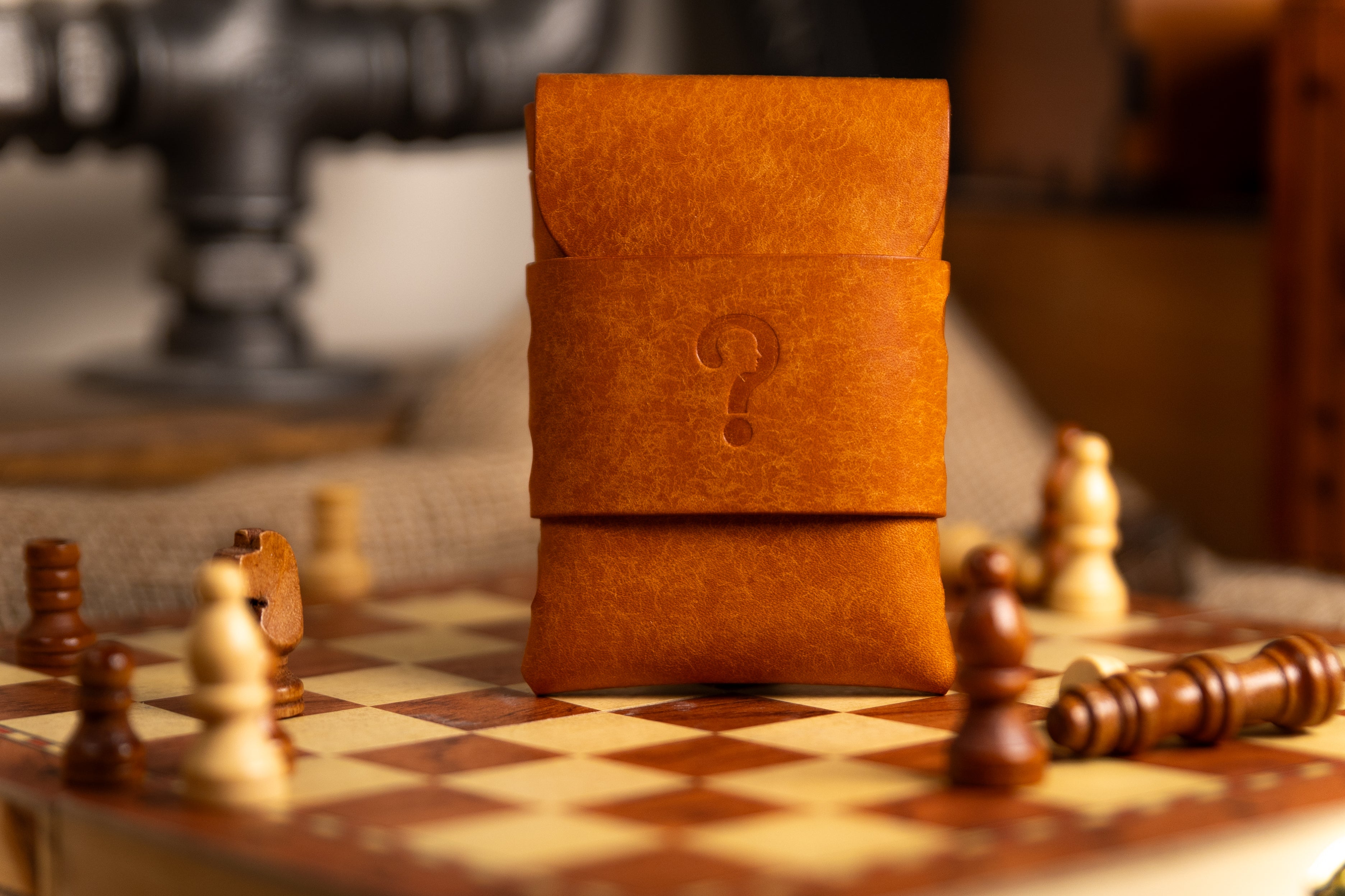 Brown pueblo leather pouch with a question mark on a chessboard