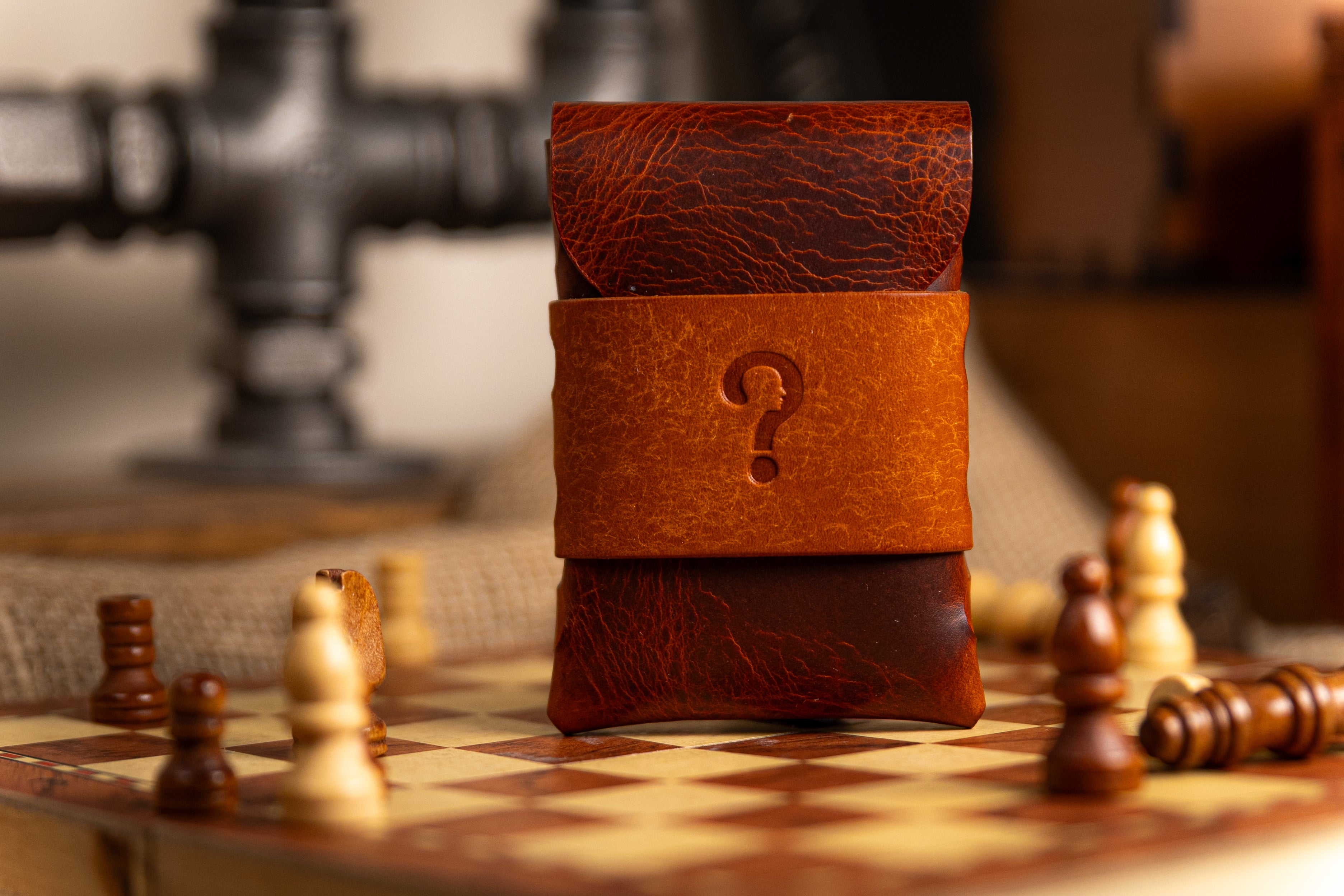 Brown  wax leather wallet with a question mark on a chessboard