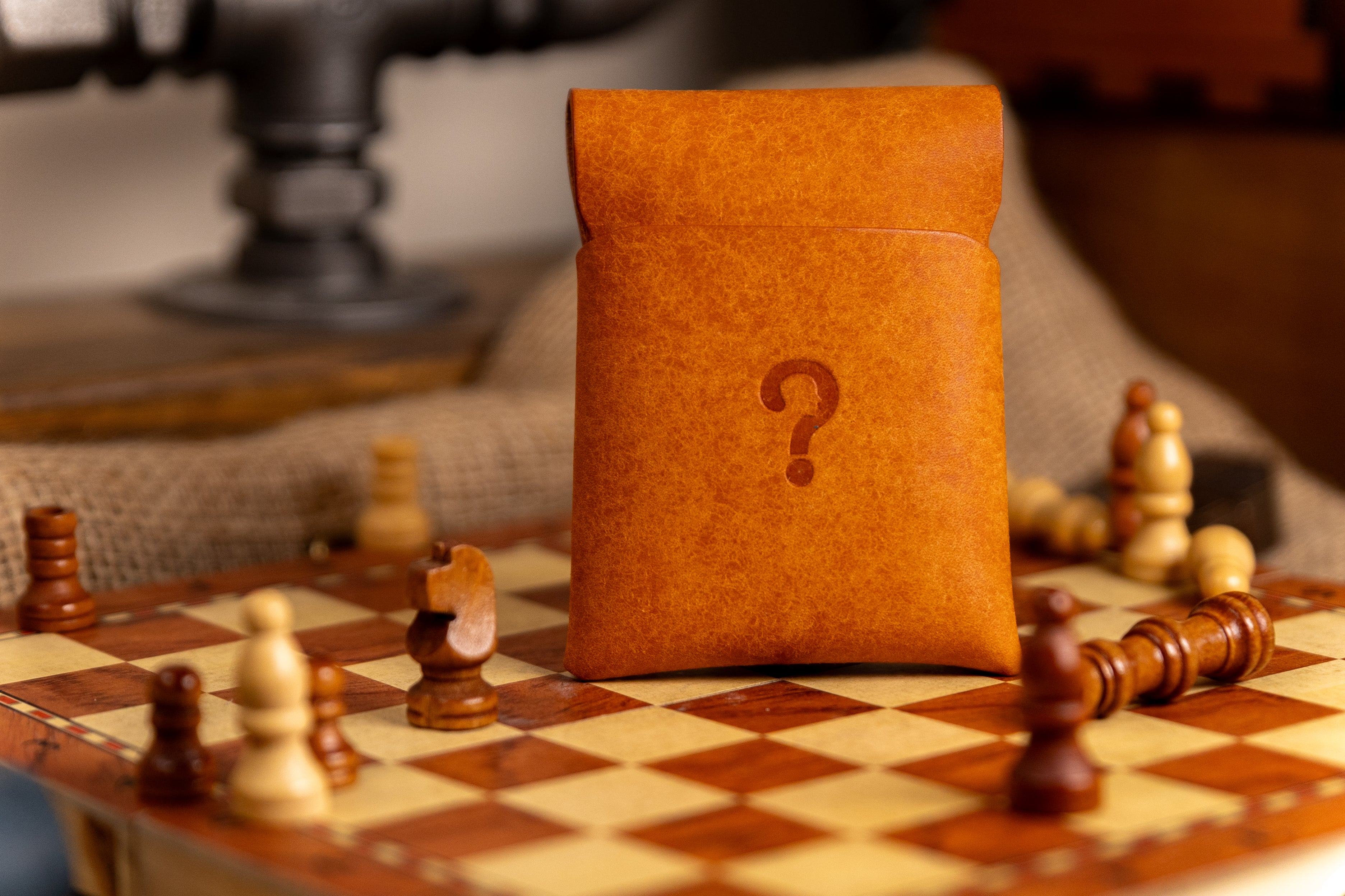 Brown pueblo leather stitchless wallet with a question mark on a chessboard