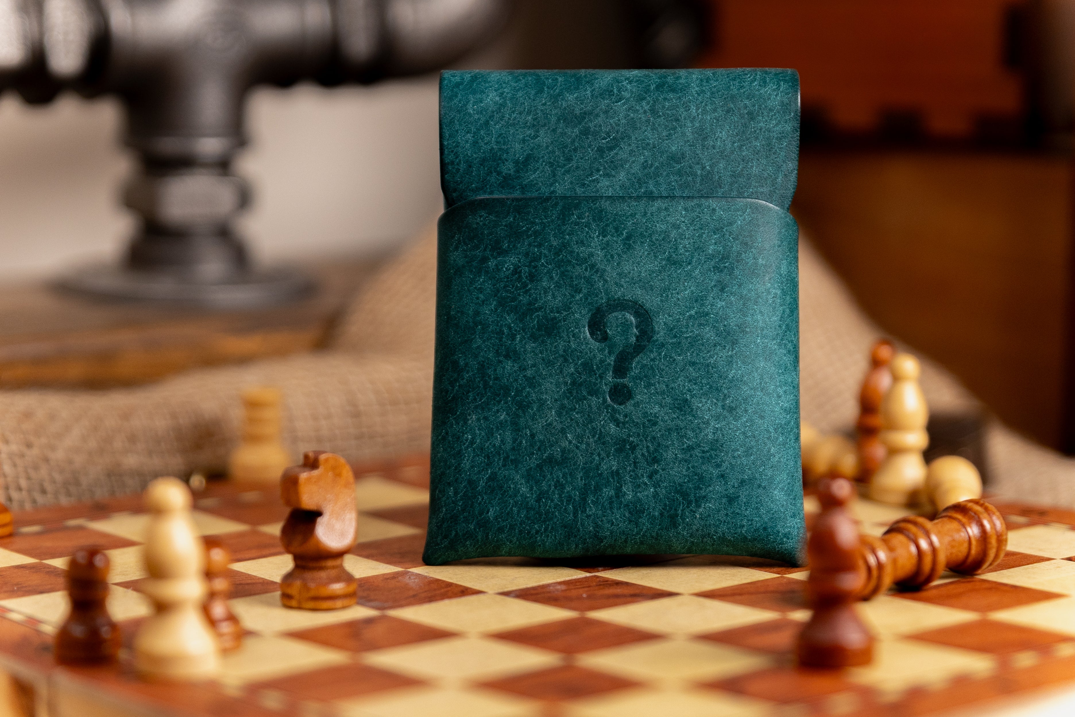 Teal pueblo leather stitchless cardholder with question mark on a chessboard