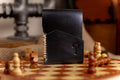 Black leather wallet with a question mark design on a chessboard