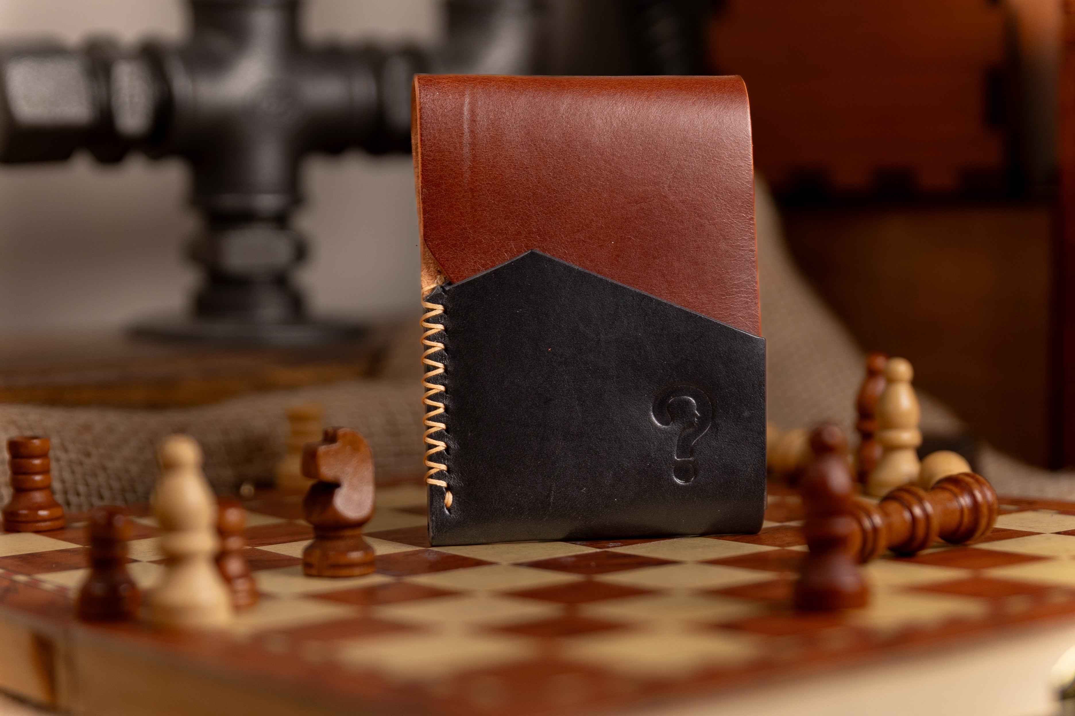 Two-tone leather wallet on a chessboard with chess pieces