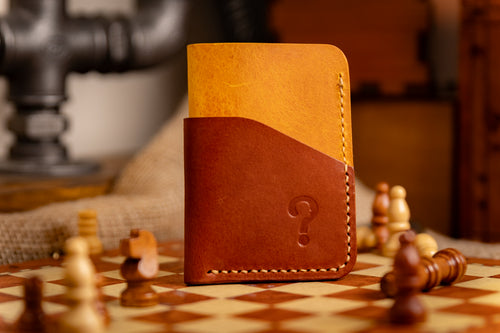 Brown leather wallet with a question mark design on a chessboard